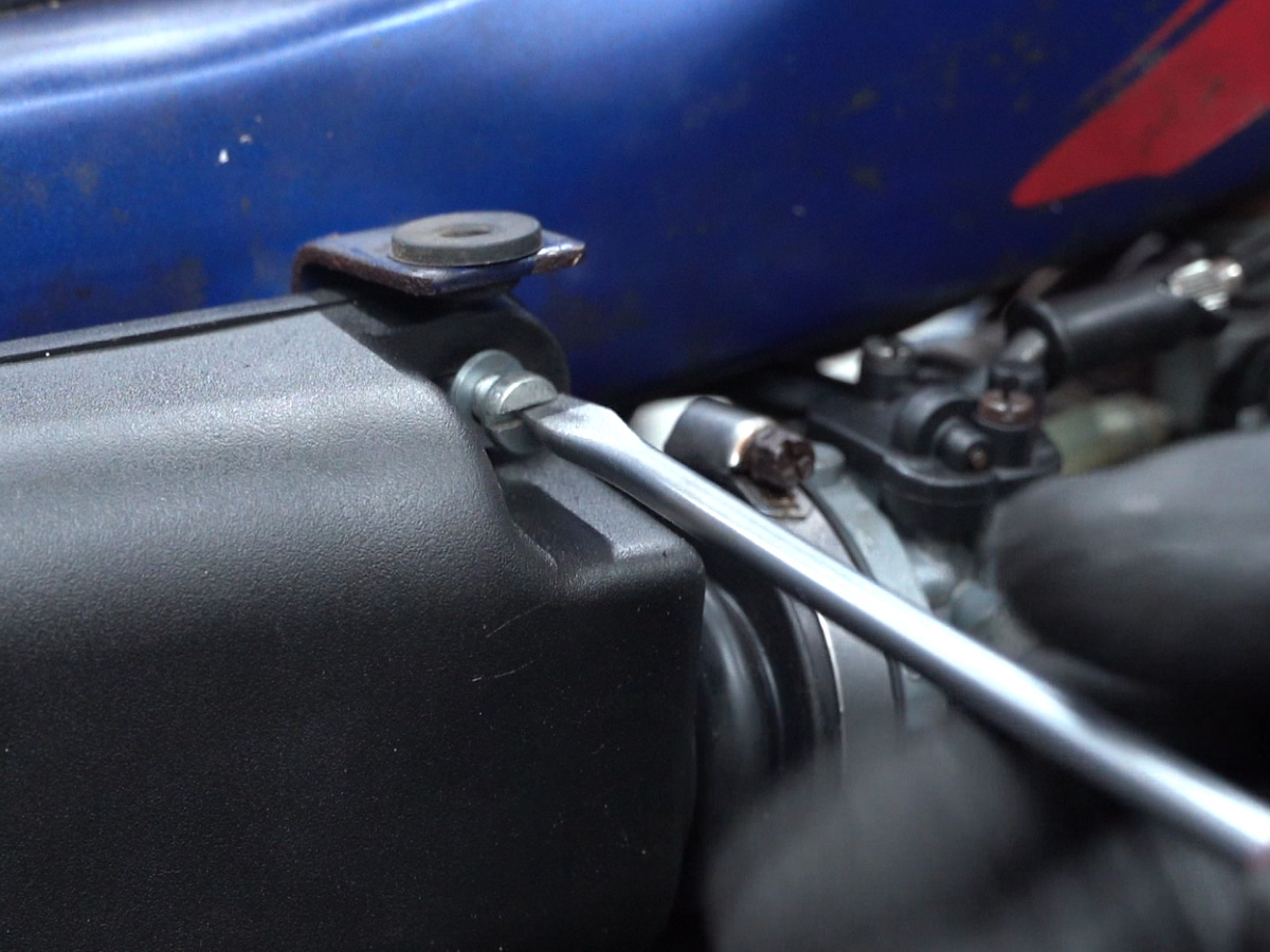 Removing the airbox to access the carburetor and engine